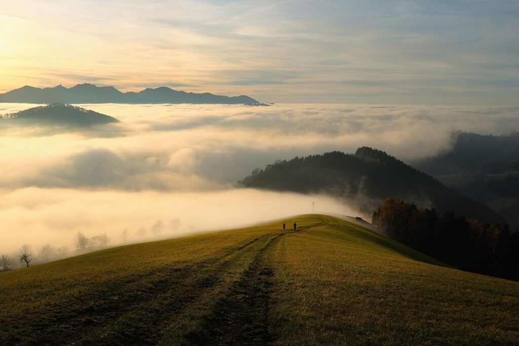 mountains, fog, sky, clouds, sea of clouds, hills, mountain range, grass, grassy, path, trail, mountain path, mountain trail, nature trail, nature path, people, silhouettes, horizon, mountain landscape, landscape, nature, foggy, morning fog, haze, mist, path, path, path, path, path, trail, mountain path, people